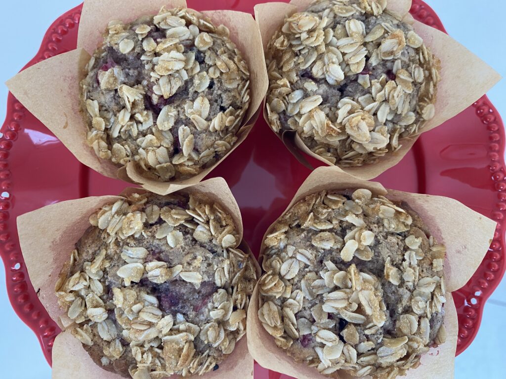 four Strawberry Banana Chocolate Chip Muffins on plate